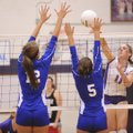 Fayetteville senior Courtney Marshall, right, kills the ball past Rogers High sophomores Allie Krabb...