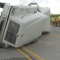 Bentonville firefighters work an accident Wednesday morning where a tractor-trailer turned over on W...