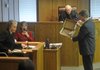 Krista Buck, left, an examiner from the Arkansas State Crime Lab, and Washington County Prosecuting Attorney John Threet discuss a knife allegedly used to stab Jill Lynn Ulmer. Buck testified Wednesday about blood evidence in the capital murder trial of Ricky Ray Anderson. Anderson is accused of killing Ulmer last year. Prosecutors are seeking the death penalty.