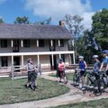 Park Ranger Martha Lacy, left, talks about the Battle of Pea Ridge with riders, from left, Marty Ker...