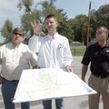 Parks commissioners Miguel Purdy, left, and David Hale, right, listen Wednesday to Dwight Heasley wi...