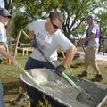 Alicia Peterson, left, of Bella Vista and Dan Ladehoff of Rogers mix concrete Thursday among platoon...