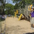 Javier Gomez with Kaboom leads the cheering Thursday at a dedication of the completed park.

