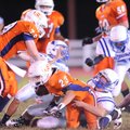 Southwest Junior High’s Gus Vitt (23) is tackled by Rogers freshman defensive end Alex McClung durin...
