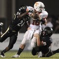 Bentonville’s DeMarcus Murphy, left, and Sean Miller combine for a sack on Texarkana, Texas, quarter...