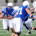 Rogers High quarterback Nick Wary looks for an opening Friday against Harrisonville, Mo.