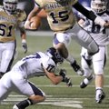 Shiloh Christian quarterback Kiehl Frazier leaps over Greenwood junior defensive back Hayden Smith i...