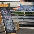 Brian Fitzpatrick of Rogers rests on bleachers Friday while waiting for Ruckus to perform in downtow...