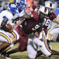 Springdale High’s Michael Wright looks to tackle North Little Rock’s Kendall Williams in the first h...