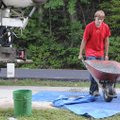 EAGLE SCOUT SOARS - Jayson Sheets, 17, pushes the last of more than 40 wheelbarrows of concrete as h...