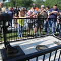 MEMORIAL DEDICATION - Area residents and veterans take pictures Saturday of the Veterans Memorial at...