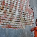 WEST FEST REST - Frauslyn Davis, 4, of Fayetteville, eats a piece of beef jerky Sunday while resting...