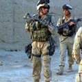 Sgt. Anthony Viggiani, left, searches a village July 9th, 2004, in the Oruzgan Province of Afghanist...