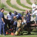 Fayetteville emergency personnel plan their route Monday to carry a worker from All Around Landscapi...