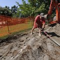 Darrell Rigsbee of Rogers smooths dirt Monday while working with a crew from DRC Construction to reb...