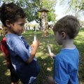 Gus Bacigalupi-Feder, left, and Aaron Henry hold peace lights Tuesday while celebrating the Internat...