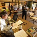 Volunteer Conrad Odom places calls Tuesday to registered voters to remind them to vote in the millag...