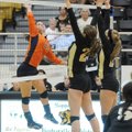 Rogers Heritage outside hitter Emily Alderson spikes the ball past Bentonville defenders during Tues...