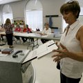Sherry Patton of Fayetteville slides her vote into the ballot box Tuesday at Central United Methodis...
