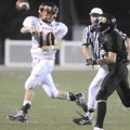 Rogers Heritage freshman quarterback Josh Qualls throws a pass Sept. 9 while being pressured by the ...