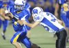 Springdale Central quarterback Kyle Pianalto is tackled by Fayetteville Woodland safety Tres Tucker during the second quarter Sept. 9 in Jarrell Williams Bulldog Stadium in Springdale.