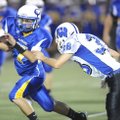 Springdale Central quarterback Kyle Pianalto is tackled by Fayetteville Woodland safety Tres Tucker ...