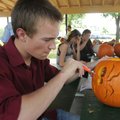 CREATIVE CARVING - Cody Cudmore carves a pumpkin Thursday during a SamsClub.com team-building event ...