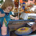 Angela Murray, 5, reacts as she gets to see her spin art for the first time at the Arkansas Apple Fe...