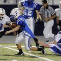 Rogers High running back Brandon Workman slips past Fayetteville Woodland defenders for extra yards ...