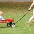 ALONG FOR THE RIDE - Crystal Gray of Fayetteville pulls her daughter, Breanna, 3, and son, Alex, 1, ...