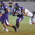 Fayetteville sophomore running back Brice Gahagans carries the ball through the Jonesboro defense du...