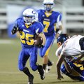 Rogers Heritage’s Josh Qualls picks up yardage as Springdale Central’s Tyler Horstman, right, pursue...