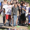 Cooper Simmons, 6, tosses a ring Friday to win a king-size bottle of soda at Apple Glen Elementary S...