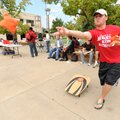 TAILGATE TOSS - Cody Lay, a junior biology major at the University of Arkansas from Rogers, throws a...