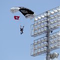A member of the U.S. Army’s Silver Wings Parachute Team jumps into Razorback Stadium on Friday as a ...