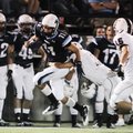 Springdale Har-Ber’s Michael Fine catches a pass as Springdale High’s Cory Shipman attempts to make ...