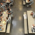 Inmates play cards and sit in a room Wednesday at the Benton County Jail in Bentonville. Some jail i...