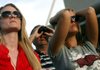 Arkansas alumni Ashley Meek (left) and Stephanie Woodruff, both of Fayetteville, watch from the northeast knoll Saturday outside Reynolds Razorback Stadium in Fayetteville as the final seconds tick down on Alabama’s 24-20 victory over the Razorbacks. More photos are at focus.arkansasonline.com.
