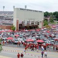 Thousands of fans gathered in parking lots and grassy areas around Razorback Stadium on Saturday to ...