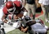 Arkansas wide receiver Jarius Wright is tackled by Alabama defensive back Robert Lester during the first quarter of the Razorbacks’ 24-20 loss to top-ranked Alabama on Saturday in Fayetteville.