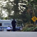 Riviera Beach police look over the house after an overnight murder-suicide that has left six people ...