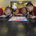 Buddhist monks Kalsang Rabten, from left, Palchen, and Gesme Tsultrim Choepel, construct a sand mand...