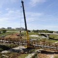 Crews from Crossland Construction use a 250-ton crane to hoist up a pedestrian walking bridge Monday...