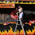 Dima Gulyayev helps set up Good Time Charlie’s BBQ tent Tuesday in the Walton Arts Center parking lo...