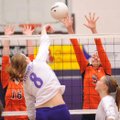 Fayetteville senior Morgan Cosby kills the ball past Rogers Heritage senior Shelby White, right, dur...