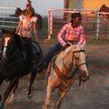 Jordan Johnson, 9, right, and Carlee Smith, 8, warm up their horses Tuesday at Parsons Stadium in Sp...