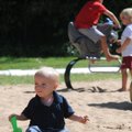 Graham Rowlison, 20 months, plays in the sand Wednesday at Lake Bella Vista Park. Graham and other a...
