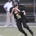 Bentonville Black’s Jacob Sisson drops back to pass on Sept. 9 against Rogers Heritage in Bentonvill...