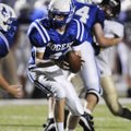 Rogers High’s Max Harrell hands off the ball against Bentonville Gold on Sept. 9 in Mountie Stadium ...