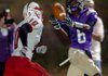 Central Arkansas Christian’s Jaylon Jones reaches back to make a reception while Camden Fairview’s Xavier Davis tries to catch him in the Cardinals’ 62-14 victory over the Mustangs.